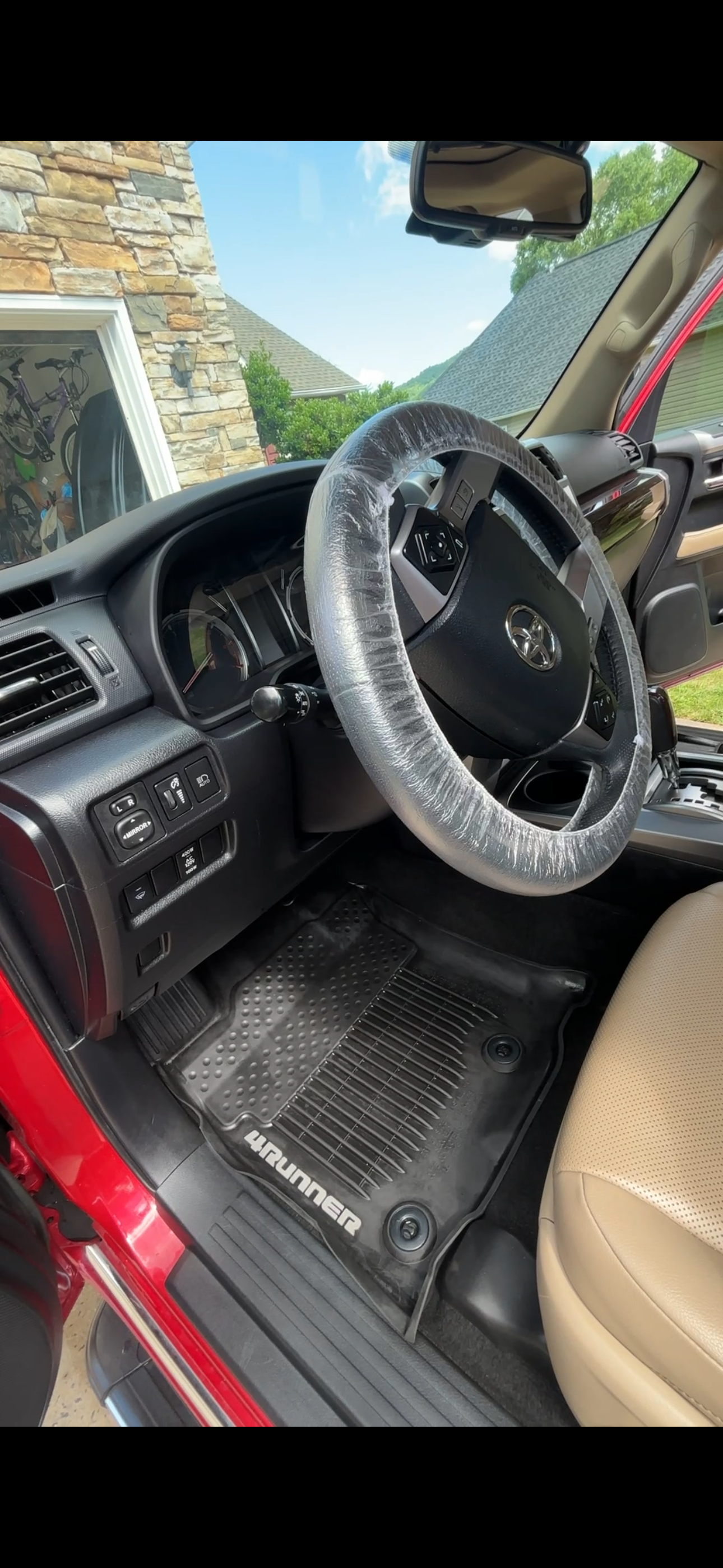 Clean Toyota 4Runner interior with protected steering wheel and floor mats